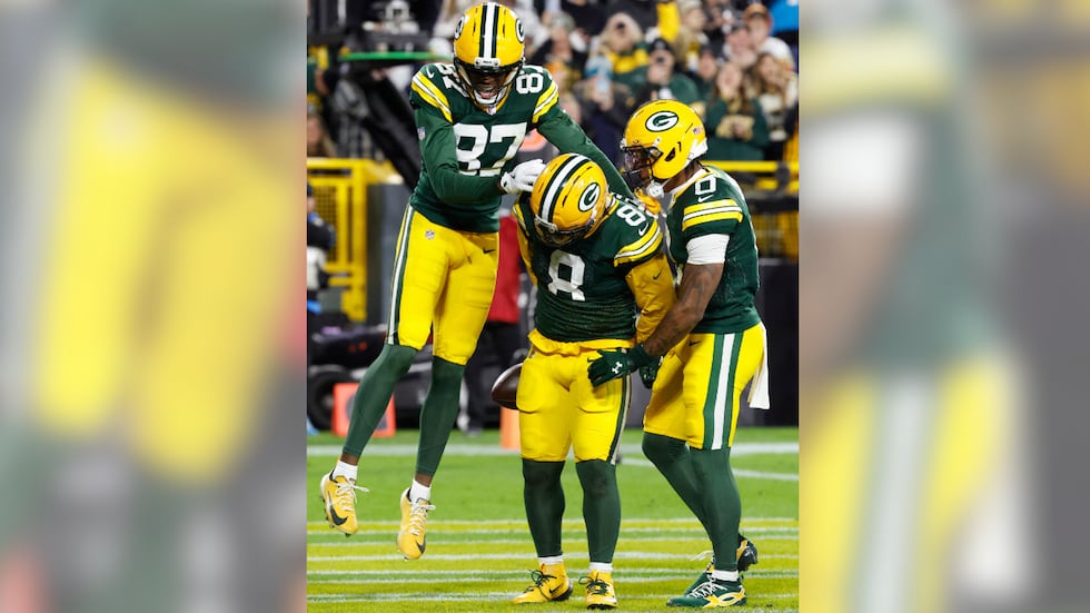 Green Bay Packers running back Josh Jacobs (8) celebrates after scoring a touchdown with wide...