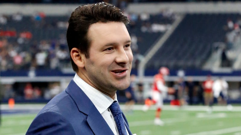 FILE - In this Nov. 5, 2017, file photo, CBS football analyst Tony Romo walks across the field...