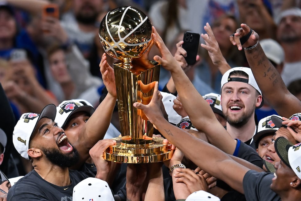 The New York Knicks celebrate with the Larry O'Brien Championship Trophy after defeating the...